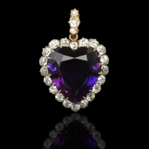 Circa 1890. A beautiful heart shaped pendant set with a richly coloured amethyst surrounded by old c