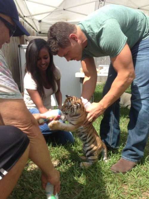 Cody with a baby tiger! I can’t handle the cuteness!!! XI