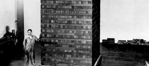 A worker stands next to one of the graphite lattice components of Chicago Pile 1. This was he first 