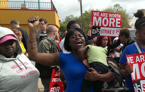 tranqualizer:  [photo: centered in the photo is a Black woman carrying a child in