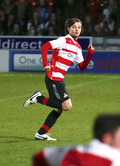 One Direction group member Louis Tomlinson made his professional football debut for Doncaster Rovers