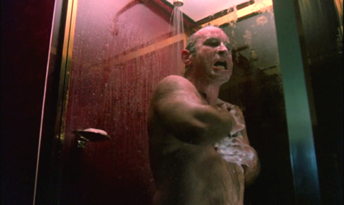 Rugged super-bear Bob Hoskins enjoys a long good shower in The Long Good Friday (1980)