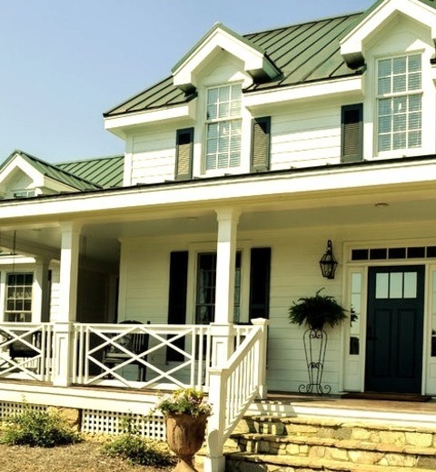 Fiberboard - Farmhouse ExteriorMetal Roofed Large Cottage With A One-story Exterior Made Of Concrete