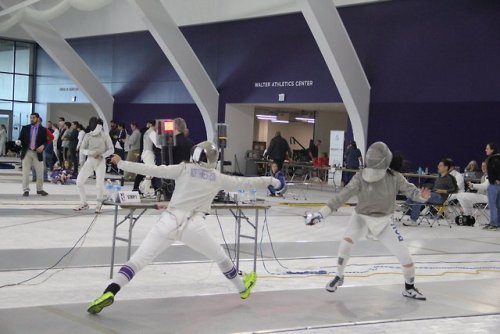 [ID: a sabre fencer lunging and hitting her opponent in preparation.]Fencing at the 2018 Remenyik!