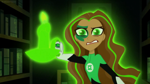 Green Lantern searches for the “monster” in the dark library. She hears a cat but s
