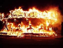 sixpenceee:   “A friend of mine who lives in Bergamo, Italy sent me a pic of a carousel that caught fire in her town. It’s eerily beautiful.” Picture by  Satan_is_my_Username  