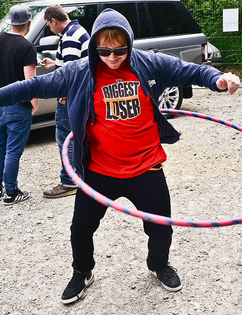 fiftyshadesen:Rupert Grint shows of his skills with a hula hoop in Stroud, Gloucestershire at the ch