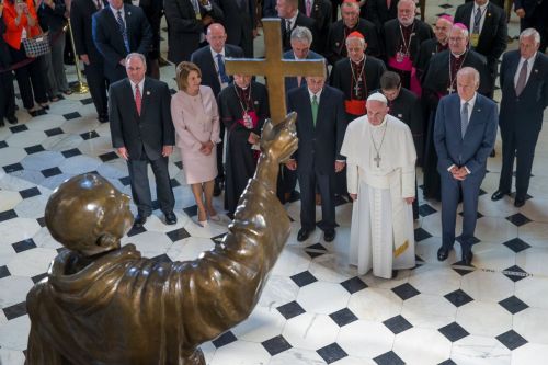 Pope Francis in front of a statue of Junipero Serra, the Franciscan Friar known for starting mission