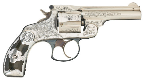 Engraved Smith and Wesso double action revolver with trimmed Tiffany style silver grips. Featured in