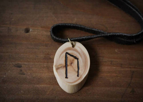 Wooden rune necklaces bearing the viking runes Dagaz, Jera, Eihwaz, Ehwaz, Nauthiz, Uruz and Gebo.Th