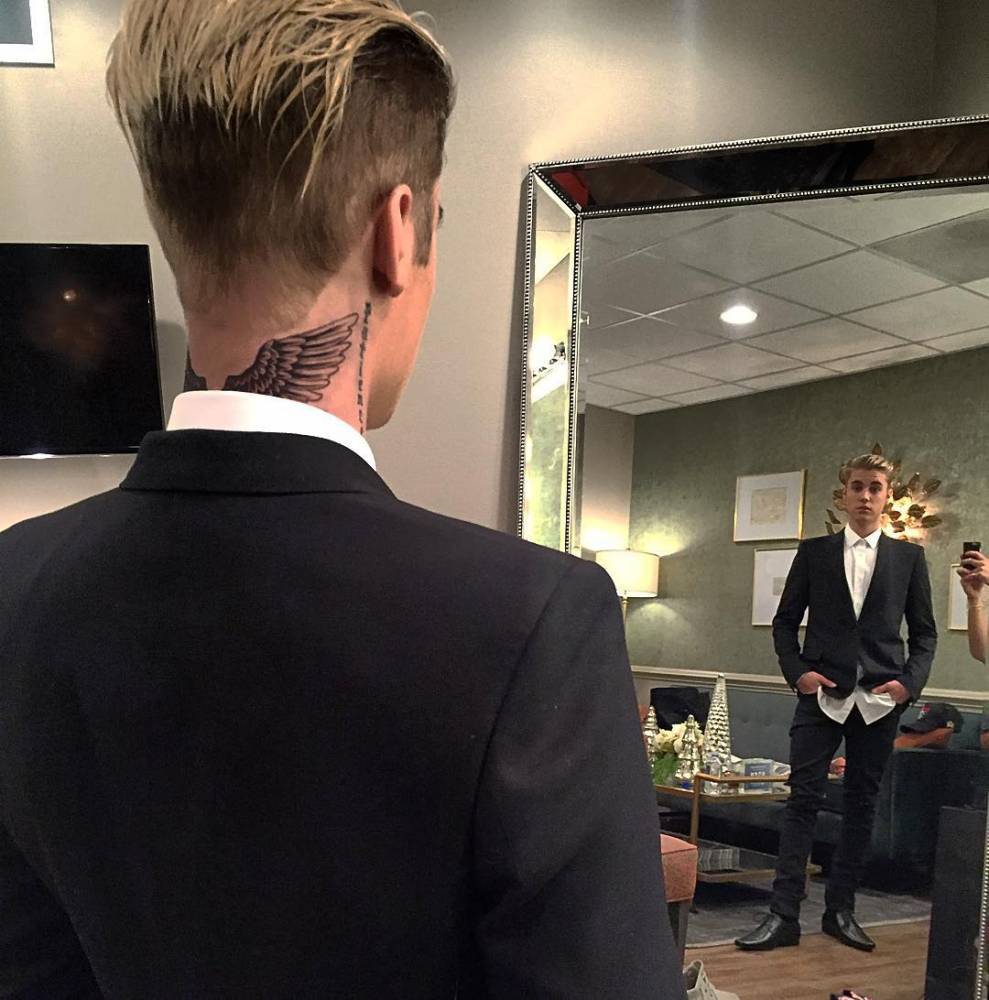 Patience tattoo behind Justin Biebers right ear