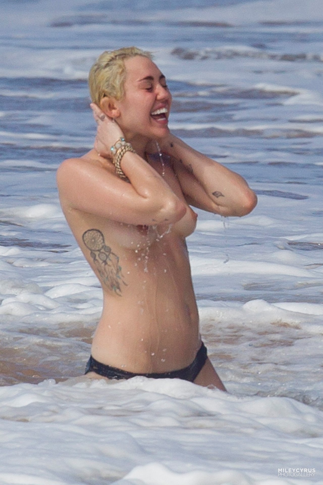 toplessbeachcelebs:  Miley Cyrus (Singer) swimming topless in Hawaii (January 2015) -