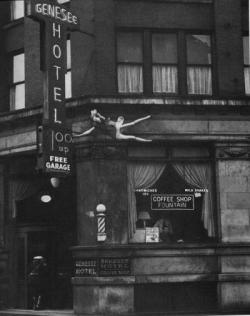 odditiesoflife:  A Leap of Death  Buffalo Courier Press photographer I. Russell Sorgi did a little impromptu ambulance chasing on his way back from another job. He wound up snapping photos of a woman standing on a ledge at the Geneese Hotel as she waved