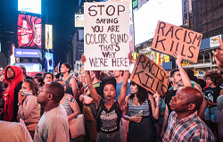 searchingforknowledge:  kingerock288:  gurl:   Why I’m Still Upset About The Trayvon Martin Verdict, And You Should Be Too  © Kevin C. Downs/ News Pictures/WENN.com  That middle sign  STOP saying you are colorblind. Thats why we’re here STOP saying