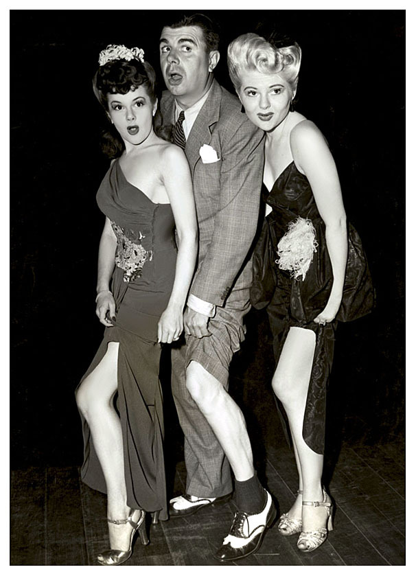 Showgirls Odessa Lauren (Left) and Doris Duane (Right) sandwich comedian: Ken Murray,