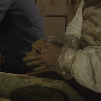 a similar frame from later on in the film, showing viago at the potter’s wheel again, this time with clear plastic covers over the ends of his sleeves to protect them from the clay.