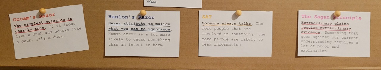 4 pieces of paper explaining Occam’s Razor, Hanlon’s Razor, the Someone Always Talks Principle, and The Sagan Principle.