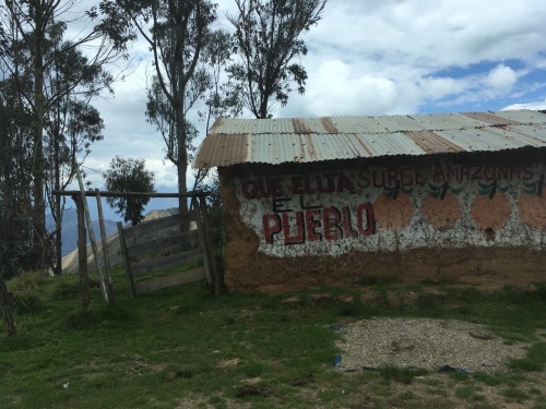 Official political signs, signals and slogans, on adobe brick and plaster walls, seen in various vil