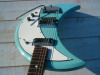 thepit:bleachedvi0let:Crucianelli Spazial 1965 Crecent Moon guitar 🌙[ID:4 pictures of an electric guitar taken from various angles. Its body is in the shape of a crescent. It’s light blue with a white pickguard. It has a vibrator arm/End ID]