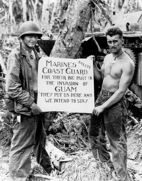 m4a1-shermayne:Two Marines hold a sign that thanks the Coast Guard for their part in the invasion of