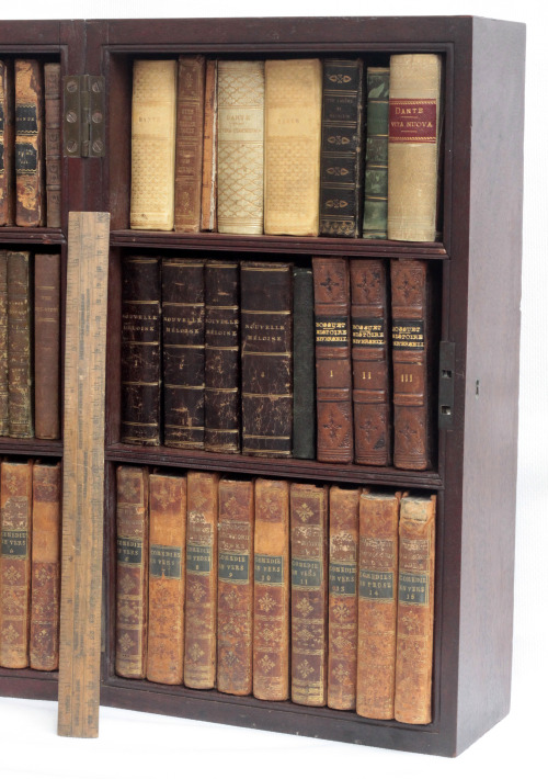 Detail showing a folding travelling bookcase complete with books next to a standard 30cms / 1&rs