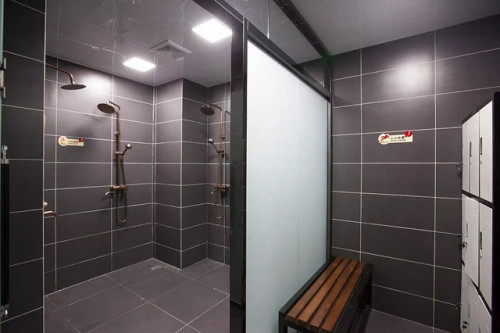 The men’s locker room and showers in D-House Gym in Shenyang, China.