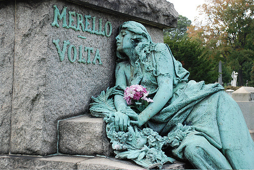 sixpenceee: Merello/Volta Monument: This 8 foot tall bronze sculpture is a depiction of a grief stricken young woman in her wedding dress. She is clutching a bouquet of flowers and appears to have fallen on the church’s steps. Time and weather have