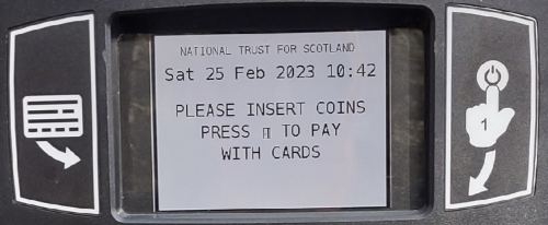 The display of the parking machine.  It says 'Please insert coins.  Press (credit card icon) to pay with cards'.  There is a credit card-like icon on the left of the display, and a finger-tap-on-the-power-on icon on the right of the display