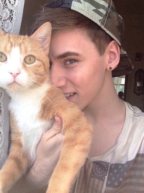 kindawasted:  selfless reblog  Nice smile on the young man, the cat doesn’t look happy.