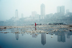 untrustyou: Ian Teh A woman walks in the shallows over the Yangtze River in Chongqing, China. With the completion of the Three Gorges Dam, the water level will rise dramatically. 
