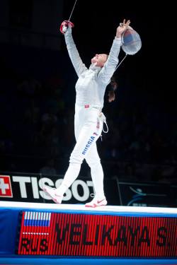 Modernfencing:  [Id: A Sabre Fencer On Strip With Her Arms In The Air In Celebration.]