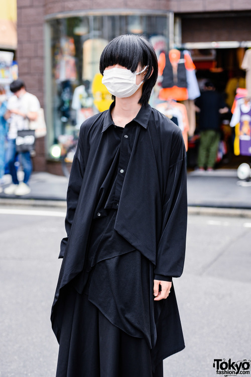 21-year-old Ryo wearing a minimalist monochrome Japanese street style in Harajuku. His clothing is b