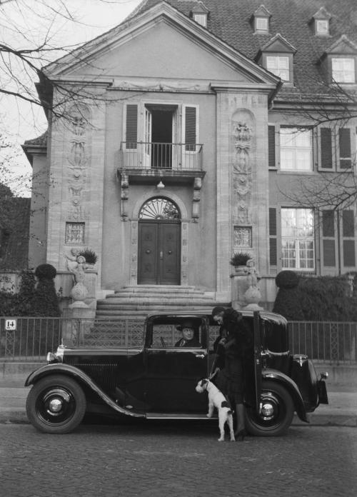 rustedshutter:  A woman and a Terrier climbing into a Mercedes-Benz | 1932  