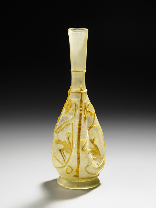 Thread glass bottle, 200-250 AD. Colorless and opaque yellow glass, free-blown, applied threads. Eas