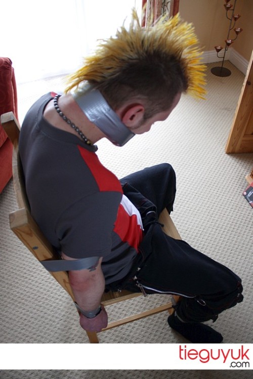 Another of my favourites from tieguyuk. I love skater/punk guys and this guy taped to a chair i