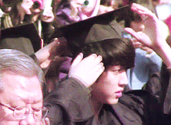 soegogi:   Lee Sungyeol student having trouble with his too-small-for-his-head graduation cap and asking Kim Sunggyu student on his right and Kim Myungsoo student on his left if he looks pretty.  