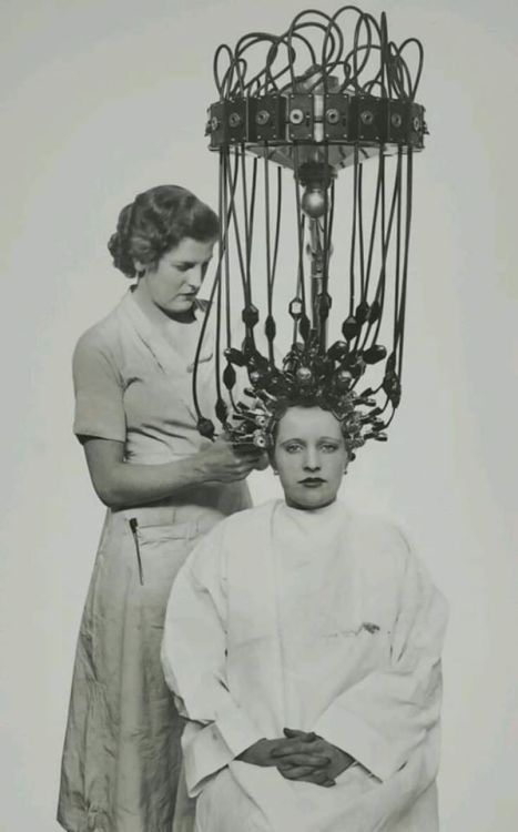 A woman has her hair permed using the Gallia machine The first person to produce a practical thermal