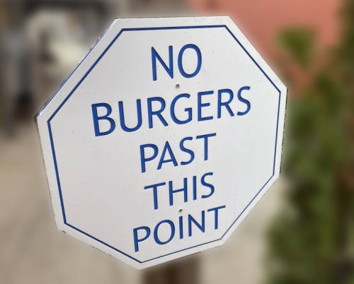 photo of an octagonal white sign that says NO BURGERS PAST THIS POINT