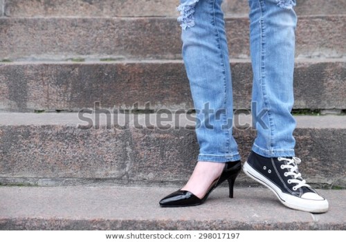 mismatched converse sneakers on legs