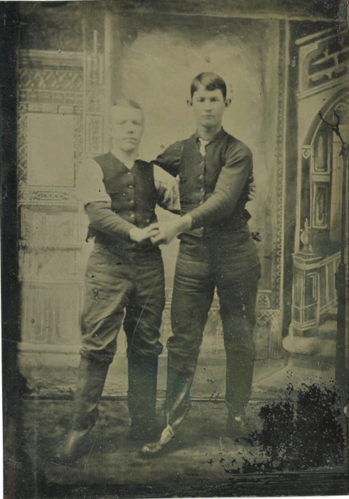 A touching tenderness between sitters in this 19th Century photograph, with their clasped hands push