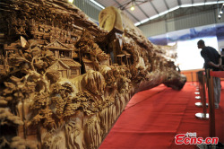 archiemcphee:  This awesomely large and intricate wooden sculpture is the work of Chinese artist Zheng Chunhui. Carved on a 40-foot-long tree trunk over the course of 4 years, this monumental work of art was recently recognized by Guinness World Records