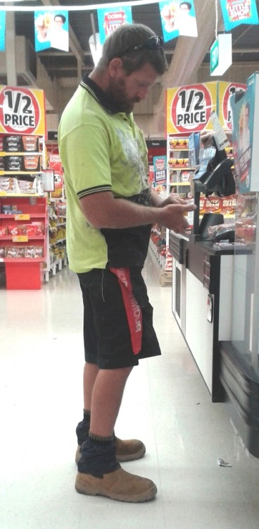 tradiewatch: Bearded tradie in messy work shirt and sock protectors at checkout