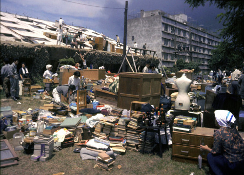 Residents pick up personal stuff from a fallen apartment a day after the Magnitude 7.5 strong earthq