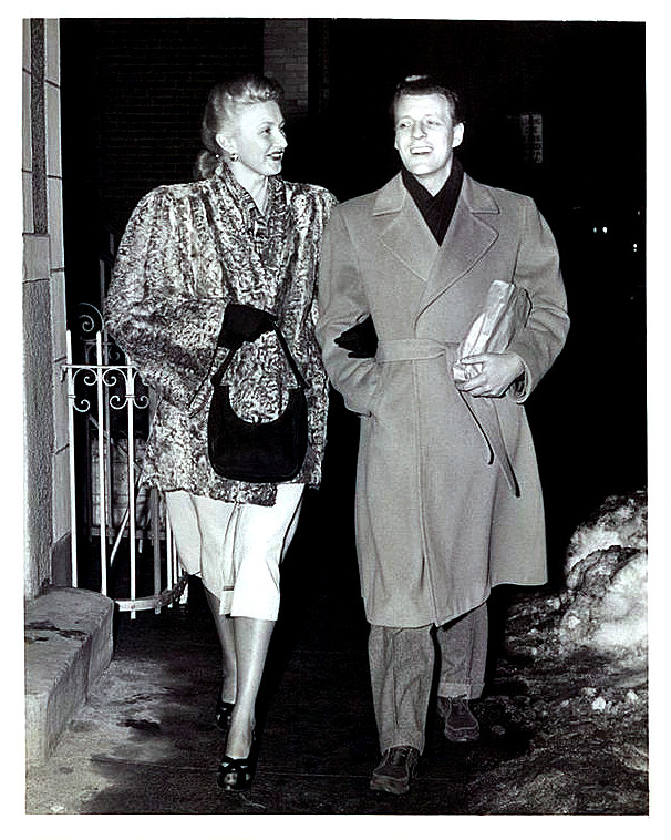 A March-2-1948 UPI press photo shows stripper Julie Bryan walking home with her husband: