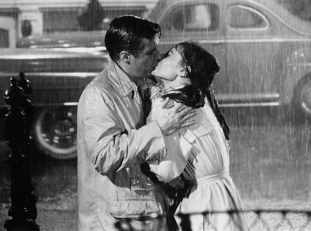 genterie:Audrey Hepburn and  George Peppard   kissing in the rain in the film Breakfast