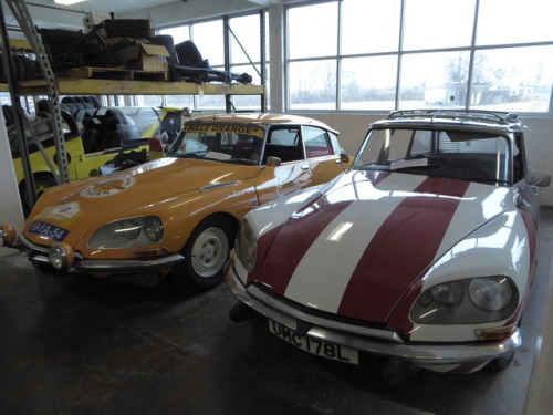 fromcruise-instoconcours:Flashy Citroen DS20 and DS21 in storage. The orange DS21 is a rally car, wh