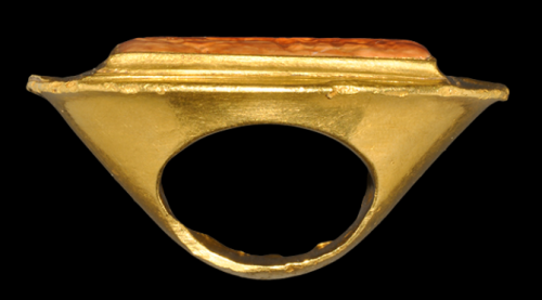 archaicwonder:  Greek Hellenistic Large Gold Ring with Nike and Quadriga, 3rd-2nd Century BCA broad D-section gold hoop extending to a large elliptical plaque with flared edge, rectangular stepped plaque with inset stone panel, intaglio design of winged