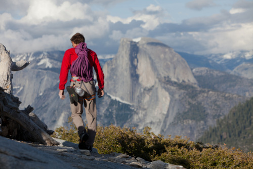 Half Dome looms behind a climber, Yosemite, California.photo: Jimmy Chin