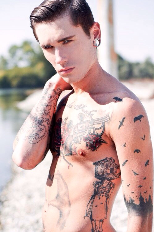 Dawid Auguscik. I like the way the bats and birds rise up from the city on his arm.