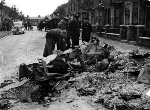 English policemen examine the wreckage of a German Messerschmitt Bf 109 which crashed onto Byron Ave